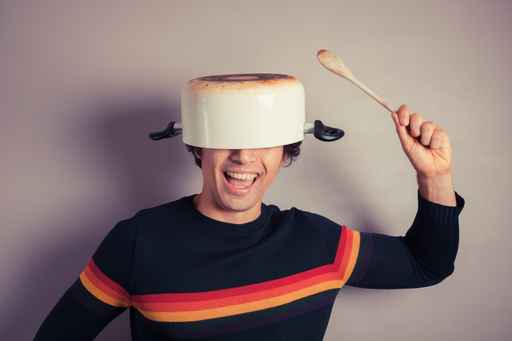 Silly young man with pot on his head Silly young man with pot on his head