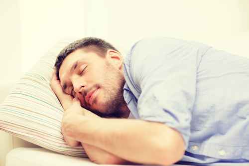 calm young man lying on sofa at home calm young man lying on sofa at home